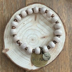 Cream ceramic beads either hand stamped charm. Great for layering.